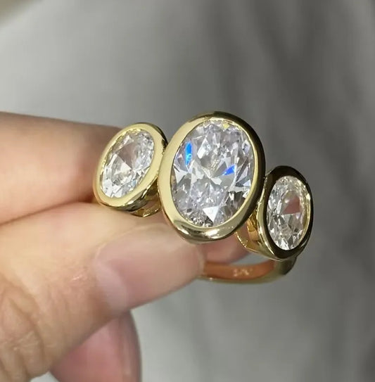 8ct Oval Cut White Sapphire Three-Stone Ring in Elegant Bezel Setting