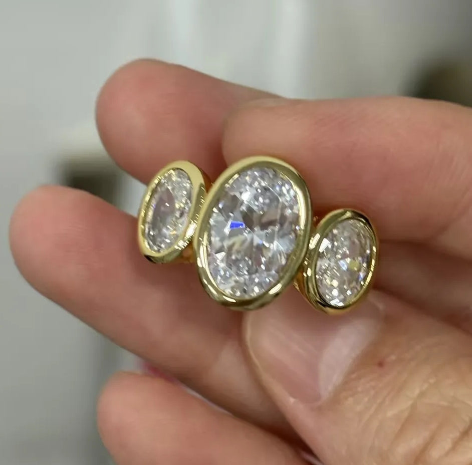 8ct Oval Cut White Sapphire Three-Stone Ring in Elegant Bezel Setting