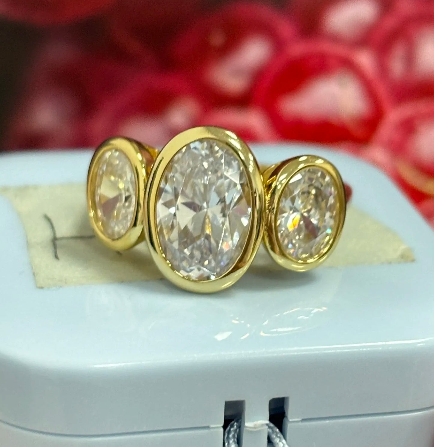 8ct Oval Cut White Sapphire Three-Stone Ring in Elegant Bezel Setting